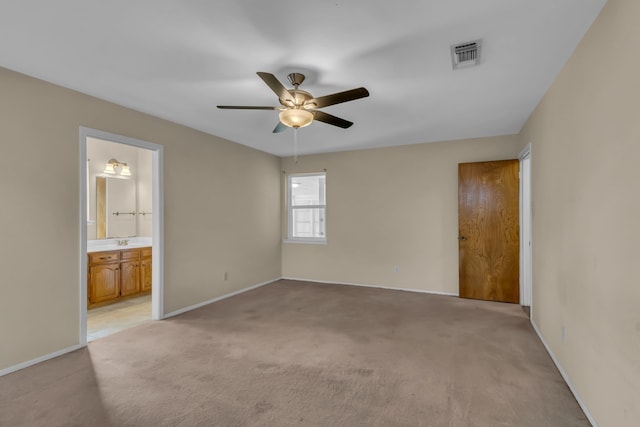 spare room featuring ceiling fan, sink, and light colored carpet