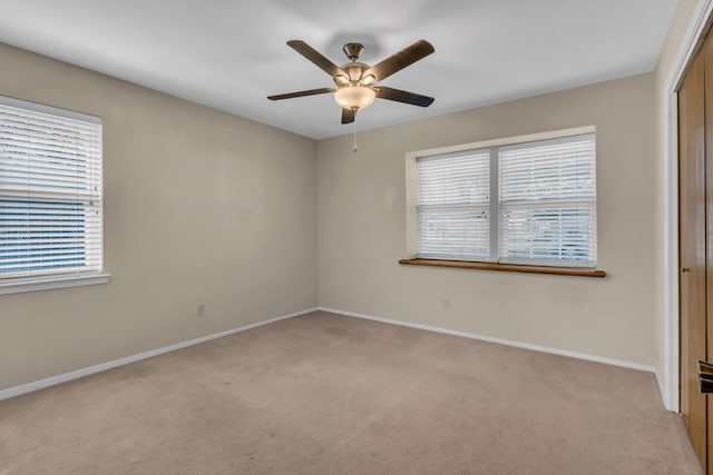 carpeted empty room with ceiling fan