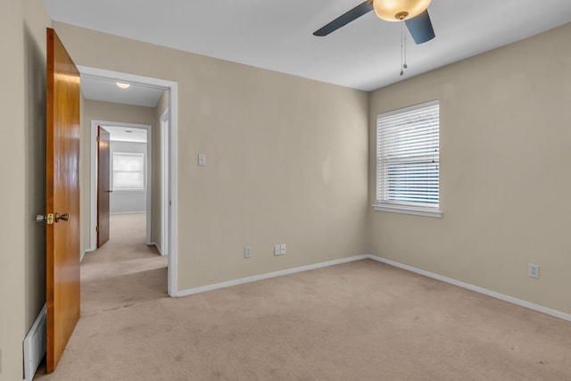 unfurnished room with ceiling fan and light colored carpet