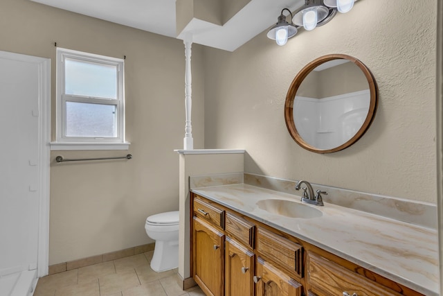 bathroom featuring tile patterned flooring, vanity, and toilet