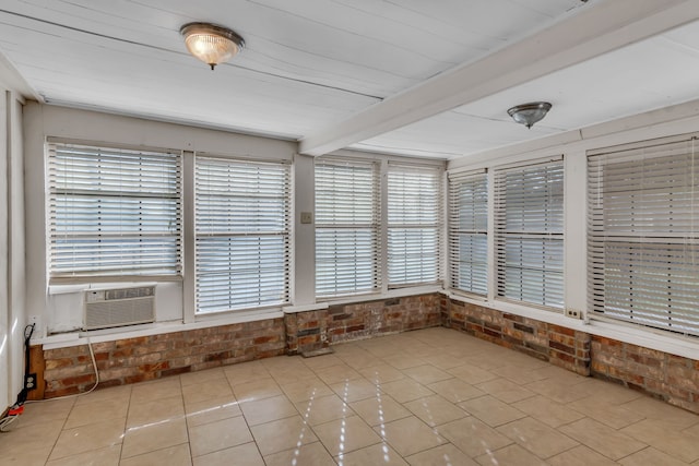 unfurnished sunroom with beamed ceiling and cooling unit