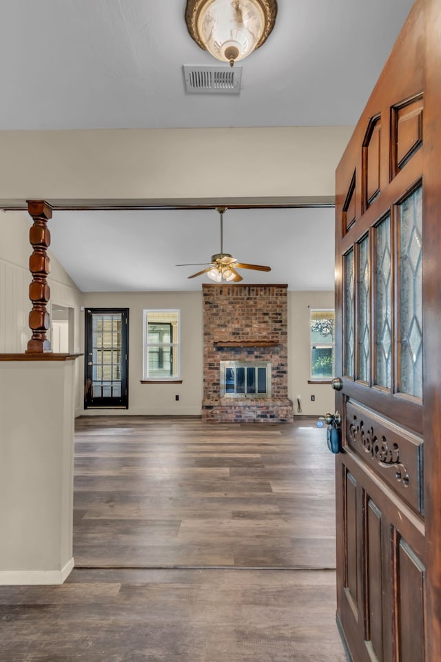 living room with dark hardwood / wood-style floors and a brick fireplace