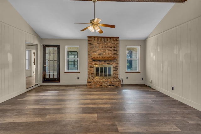 unfurnished living room with dark hardwood / wood-style flooring, a brick fireplace, ceiling fan, and lofted ceiling