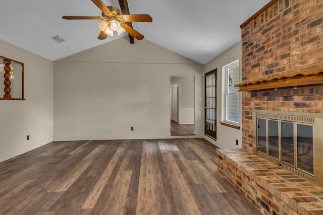 unfurnished living room with lofted ceiling with beams, dark hardwood / wood-style floors, a fireplace, and ceiling fan