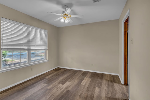 spare room featuring wood-type flooring and ceiling fan