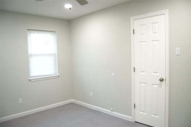 spare room with ceiling fan and plenty of natural light