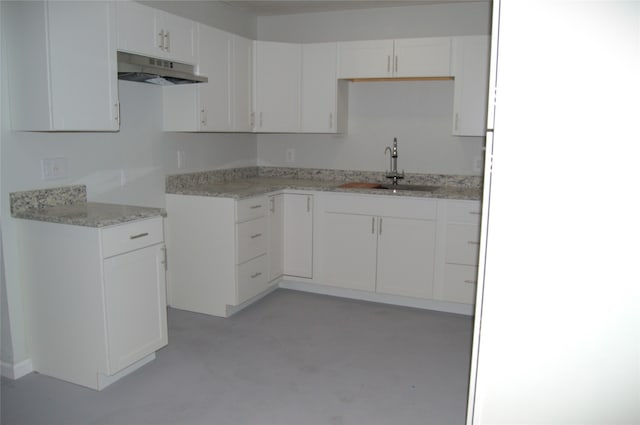 kitchen featuring white cabinets and sink