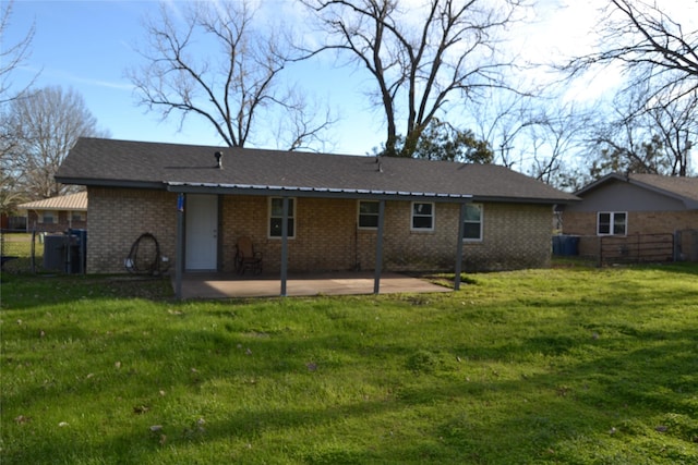 rear view of property with a yard and a patio area