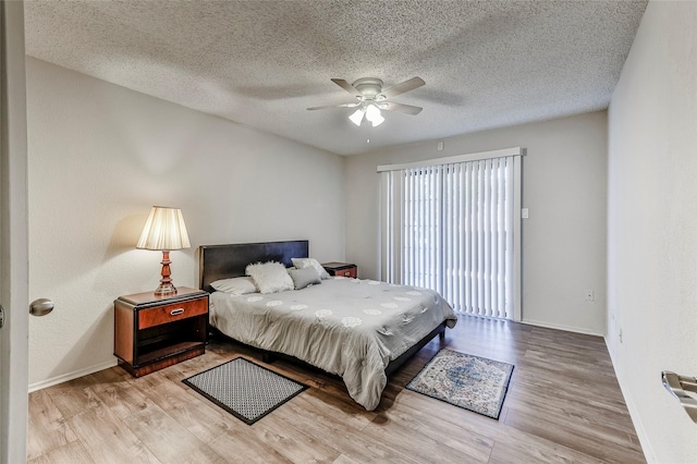 bedroom with a textured ceiling, light wood-type flooring, and ceiling fan