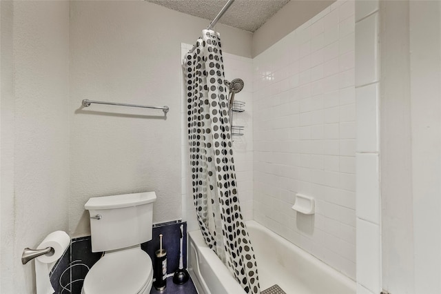 bathroom featuring shower / bathtub combination with curtain, toilet, and a textured ceiling