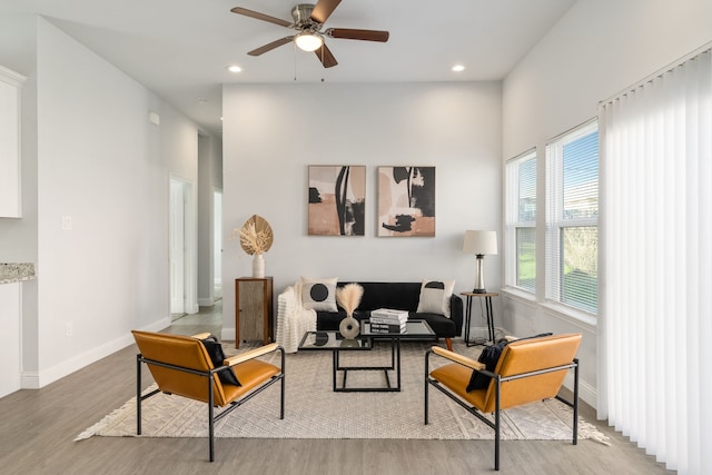 living room with ceiling fan and light wood-type flooring