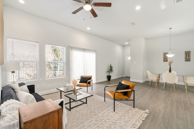 living room featuring ceiling fan and light hardwood / wood-style flooring