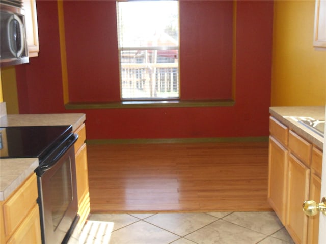 kitchen featuring appliances with stainless steel finishes and light tile patterned flooring