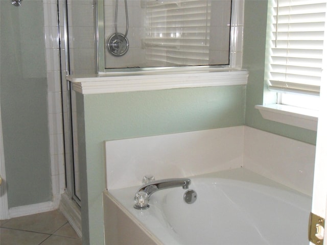 bathroom featuring plus walk in shower and tile patterned floors