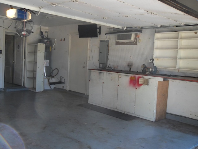 garage with a workshop area, a garage door opener, electric panel, water heater, and a wall unit AC