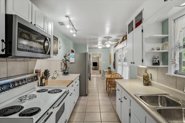 kitchen with open shelves, visible vents, appliances with stainless steel finishes, white cabinets, and a sink