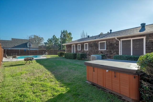 view of yard featuring a fenced in pool, central AC, a hot tub, and a fenced backyard