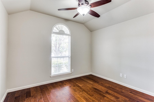 unfurnished room with dark wood-type flooring, plenty of natural light, and lofted ceiling