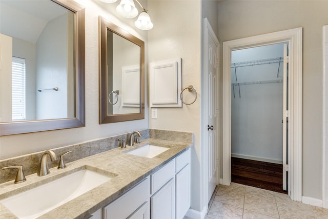 bathroom featuring tile patterned floors, vanity, and lofted ceiling