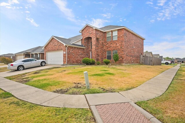 view of front facade with a garage and a front lawn