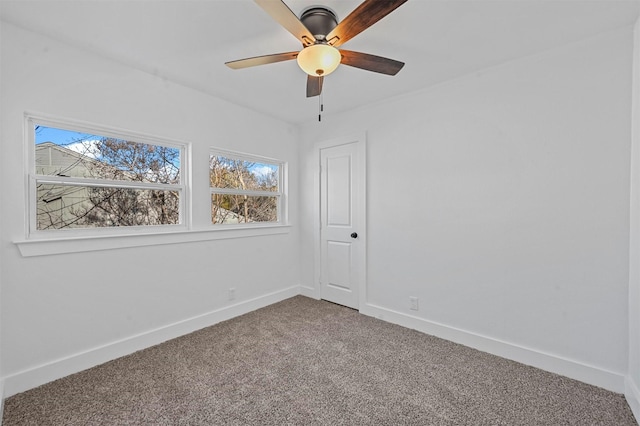 spare room featuring ceiling fan and carpet flooring