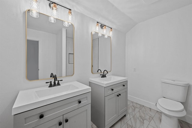 bathroom featuring vanity, vaulted ceiling, and toilet