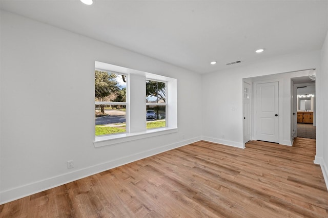 spare room with light hardwood / wood-style floors