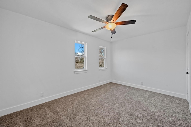 carpeted spare room featuring ceiling fan