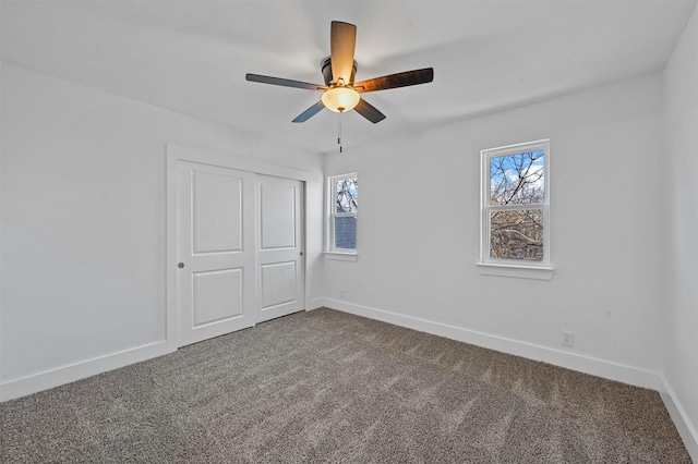 unfurnished bedroom featuring a closet, ceiling fan, and carpet flooring