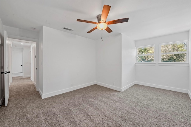 spare room with ceiling fan and light carpet