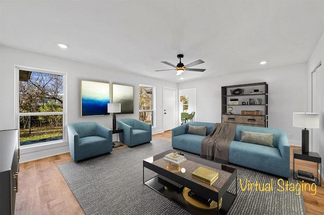 living room with hardwood / wood-style floors and ceiling fan