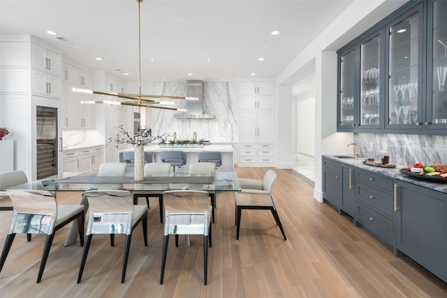 dining space featuring light hardwood / wood-style floors and sink