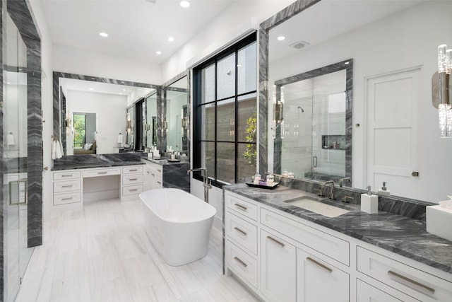 bathroom with vanity and independent shower and bath