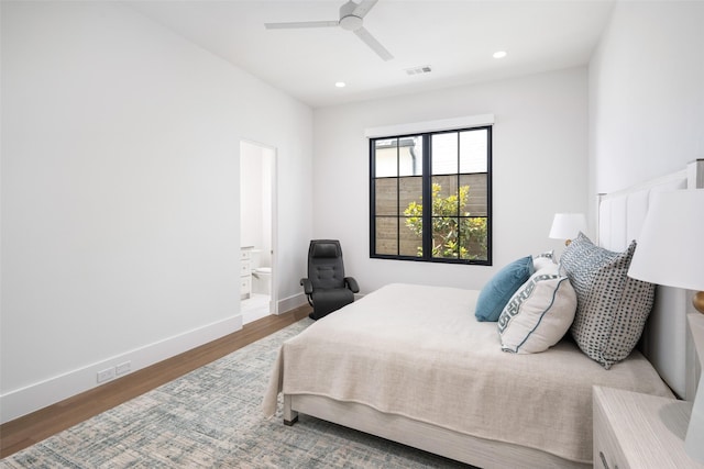 bedroom with ensuite bathroom, hardwood / wood-style floors, and ceiling fan