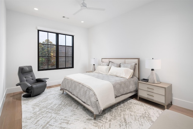 bedroom with light hardwood / wood-style floors and ceiling fan