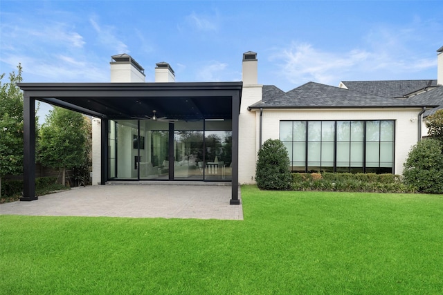 rear view of house featuring a sunroom and a yard