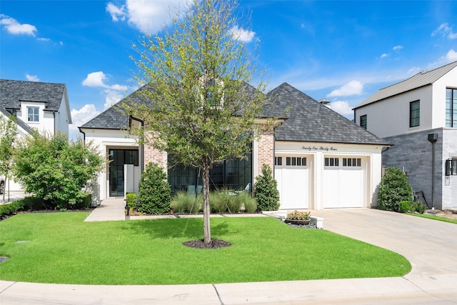 view of front of house with a garage and a front lawn