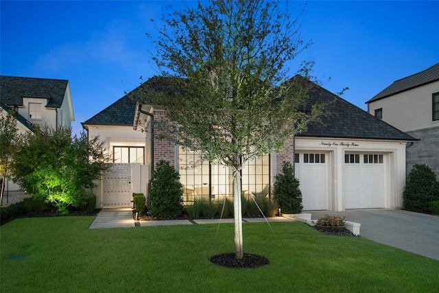 view of front facade featuring a garage and a front lawn