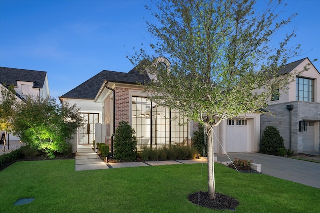 view of front of home featuring a garage and a front lawn