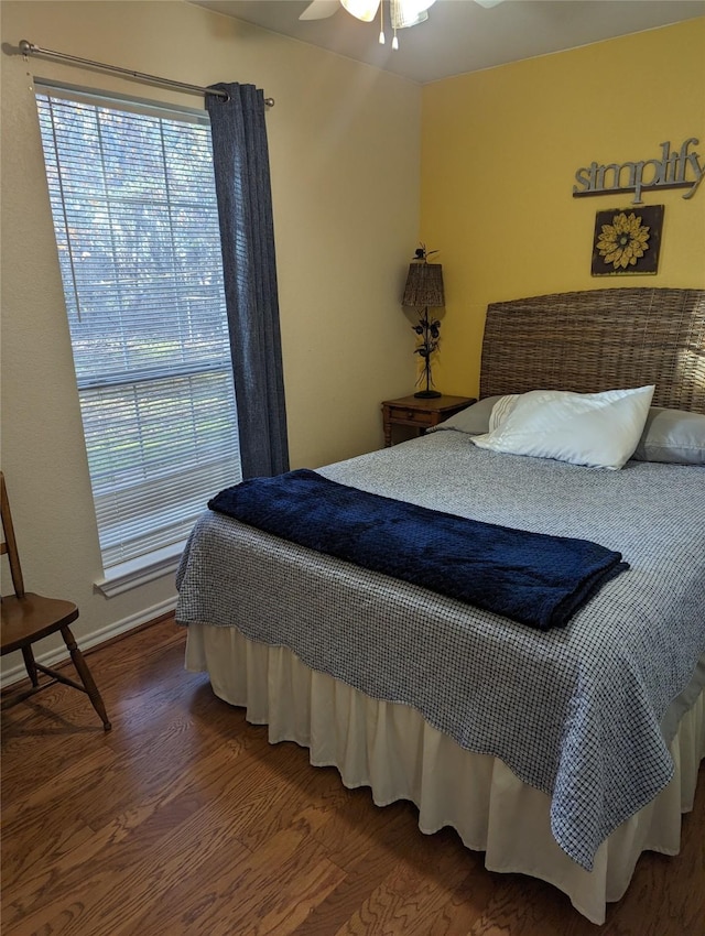 bedroom with ceiling fan and dark hardwood / wood-style flooring