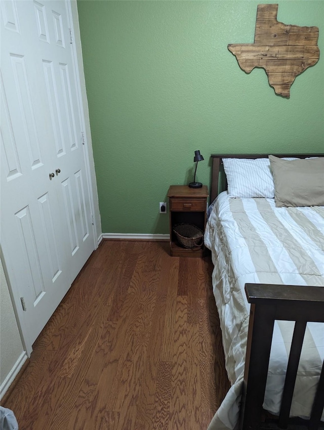 bedroom featuring a closet and dark wood-type flooring