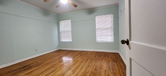 spare room with hardwood / wood-style flooring and ceiling fan