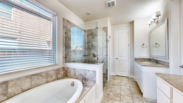 bathroom featuring tile patterned floors, vanity, and plus walk in shower