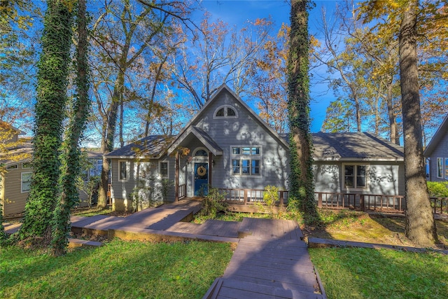 view of front facade featuring a deck and a front yard