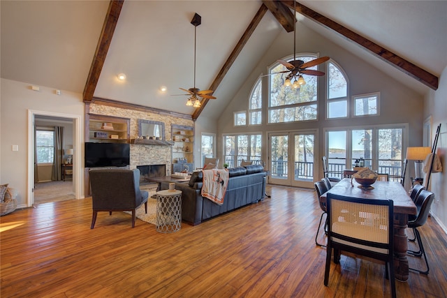 living room featuring ceiling fan, plenty of natural light, and high vaulted ceiling