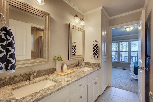 bathroom featuring tile patterned flooring, ornamental molding, and vanity