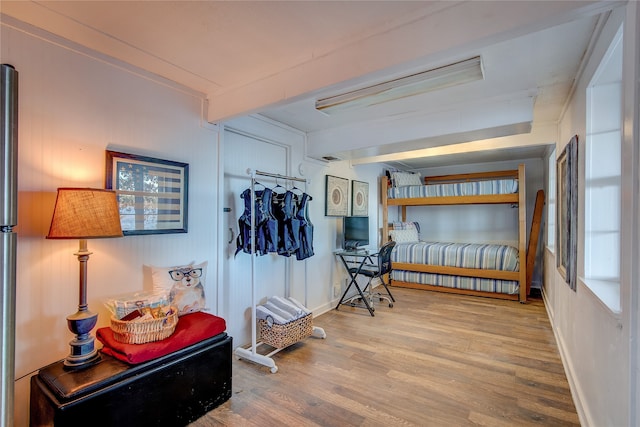 interior space featuring beamed ceiling and hardwood / wood-style floors