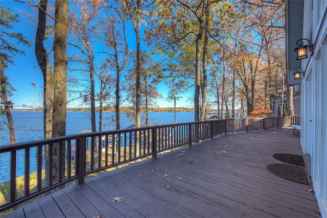 wooden terrace featuring a water view