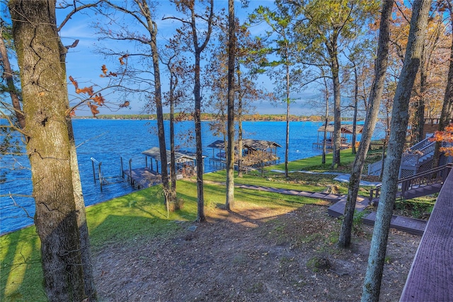 view of yard featuring a dock and a water view