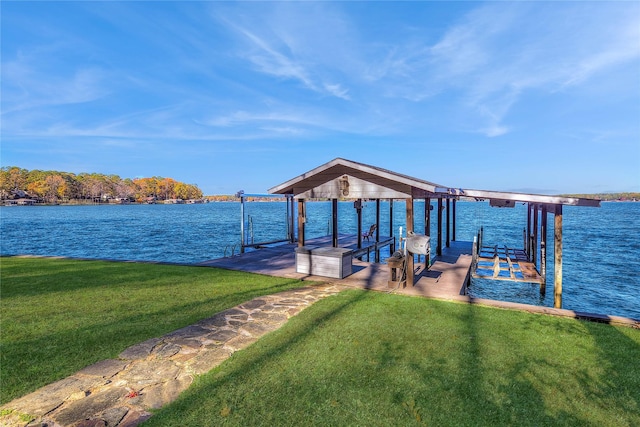 dock area featuring a lawn and a water view